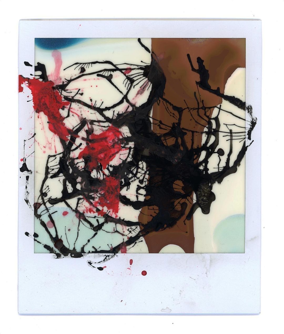 Abstract art on a white background features black, red and brown paint splatters and lines, creating a unique visual pattern.