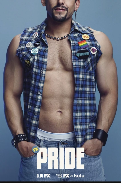 Promotional portrait of muscular adult man wearing a plaid vest with buttons, wristbands, and jeans against a light blue background.