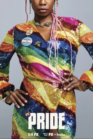 Close-up of a Black woman in a rainbow sequin dress adorned with buttons, paired with pink hair and jewelry, set against a gray backdrop.