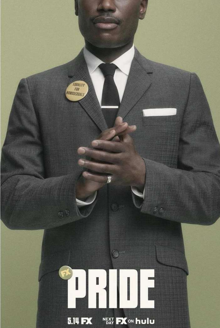 Portrait of a Black man in a suit with a button reading 'Equality for Homosexuals,' against a light green backdrop for the 'Pride' series.