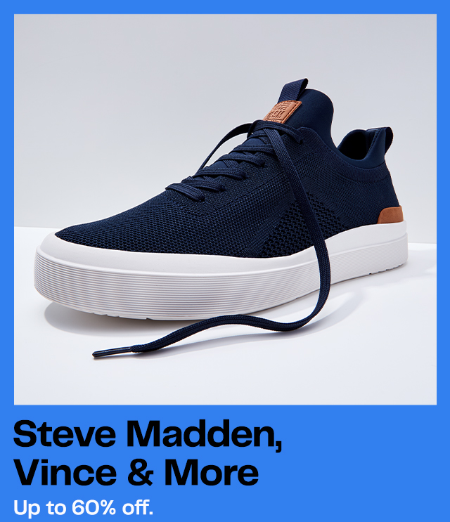 Navy blue fashion sneaker with white sole, brown leather accent. Sleek lace-up design. Fashion footwear for men, studio shot.