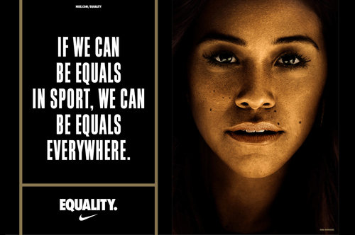Portrait of adult woman next to text-based Nike equality advertisement with tagline: If we can be equals in sport, we can be equals everywhere.