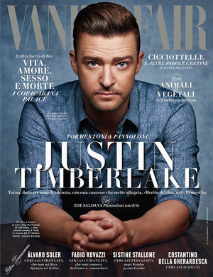 Justin Timberlake gazes intently on a magazine cover, in a medium shot, wearing a blue shirt, with the magazine title 'Vanity Fair' above him.