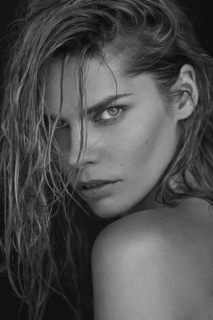 Close-up portrait of a woman with wet hair and direct gaze in monochrome by Frankie Batista