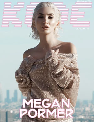 Magazine cover featuring a blonde model in a shimmering gold dress, set against a cityscape backdrop under a clear sky, with bold title text.