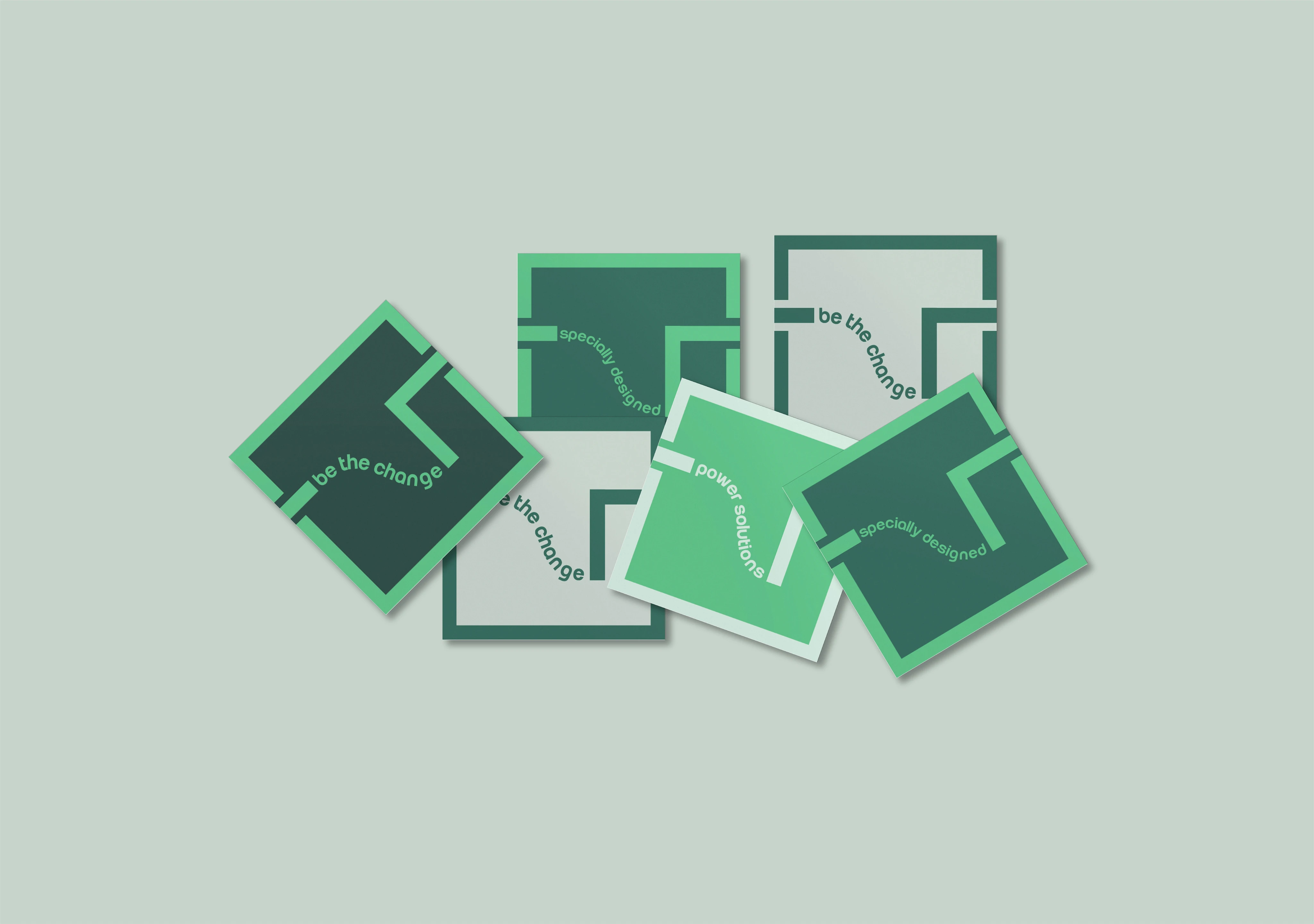 Scattered square cards display branding with graphic design elements and text overlays on a pale green backdrop, studio lighting.