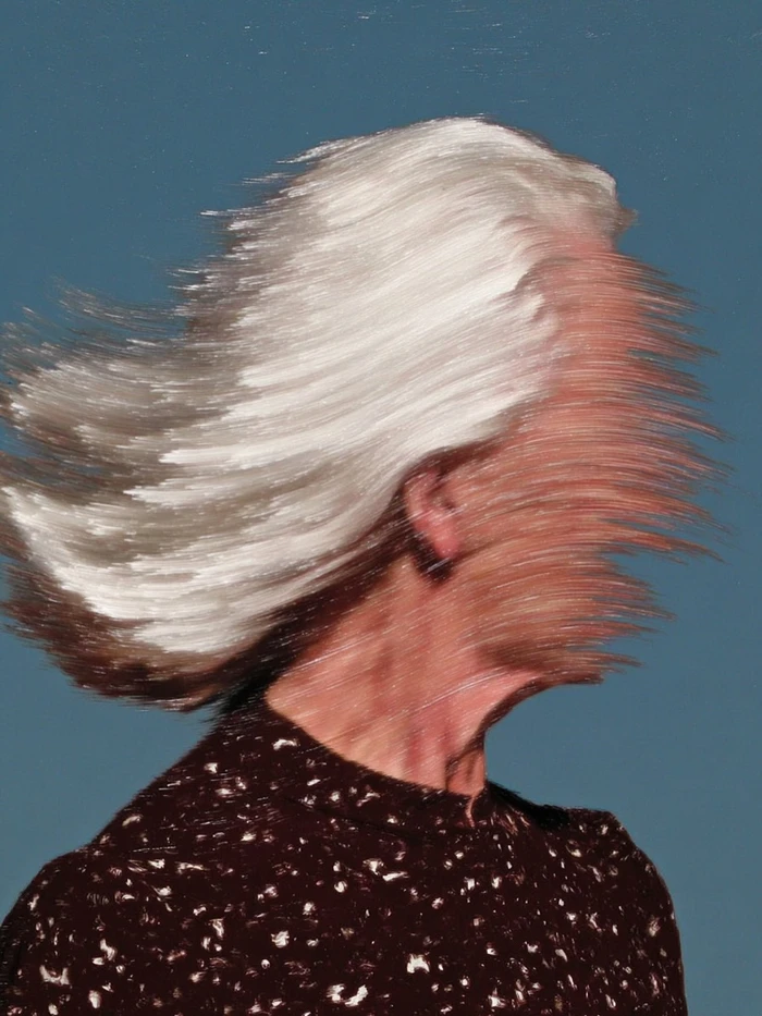 Surreal digital portrait of an individual with white hair and motion-blurred facial features against a clear blue background.