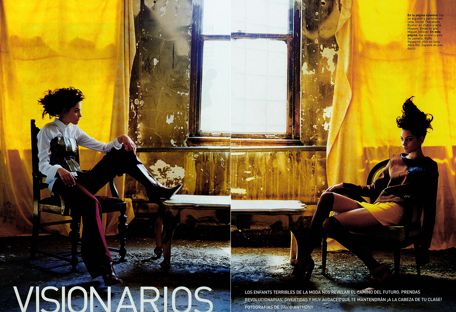 Two women in high fashion attire are seated in an abandoned-style room with peeling paint and a window, illuminated by a yellow curtain.
