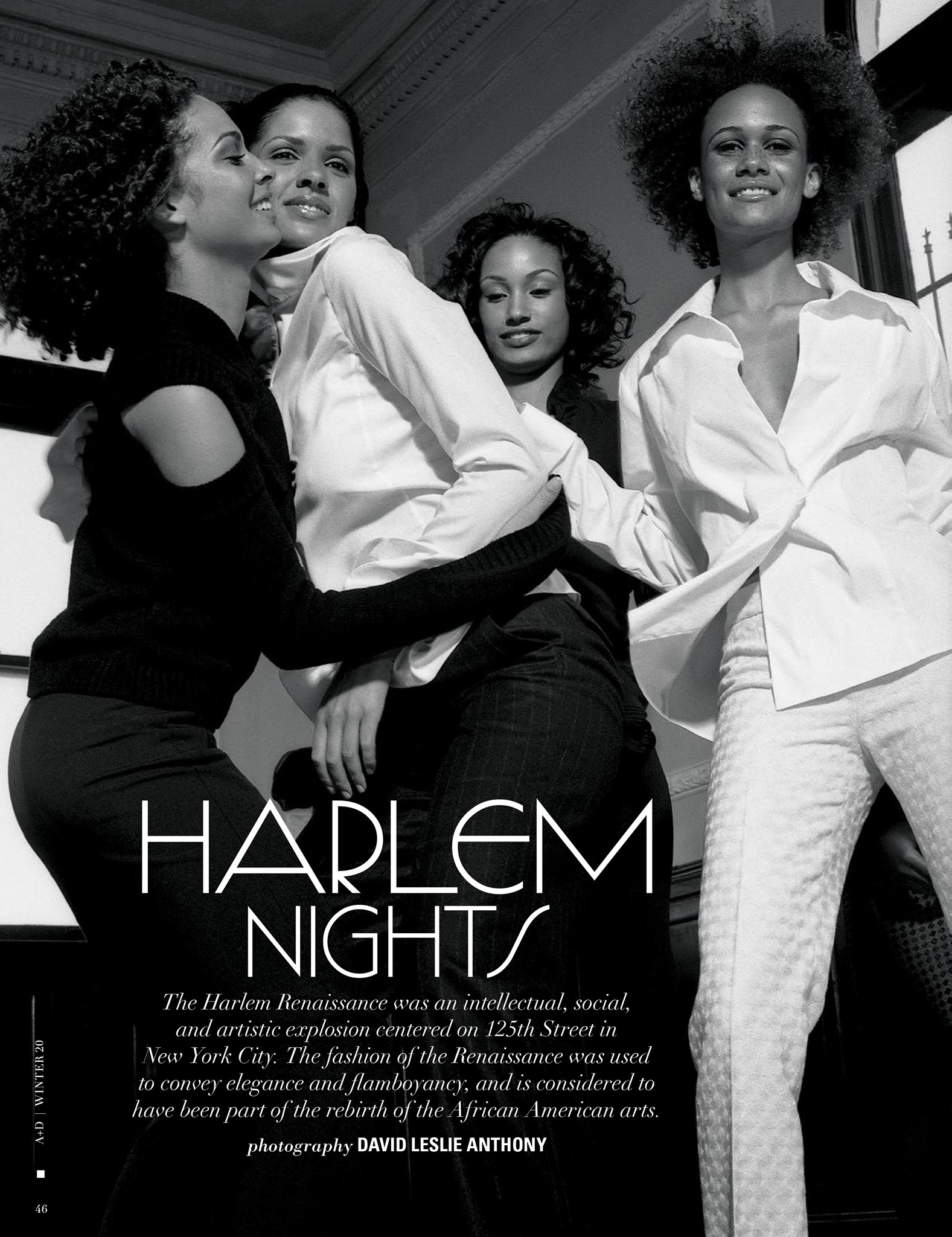 Black and white image of four African-American women in a fashion editorial, wearing white blouses and dark pants and smiling.