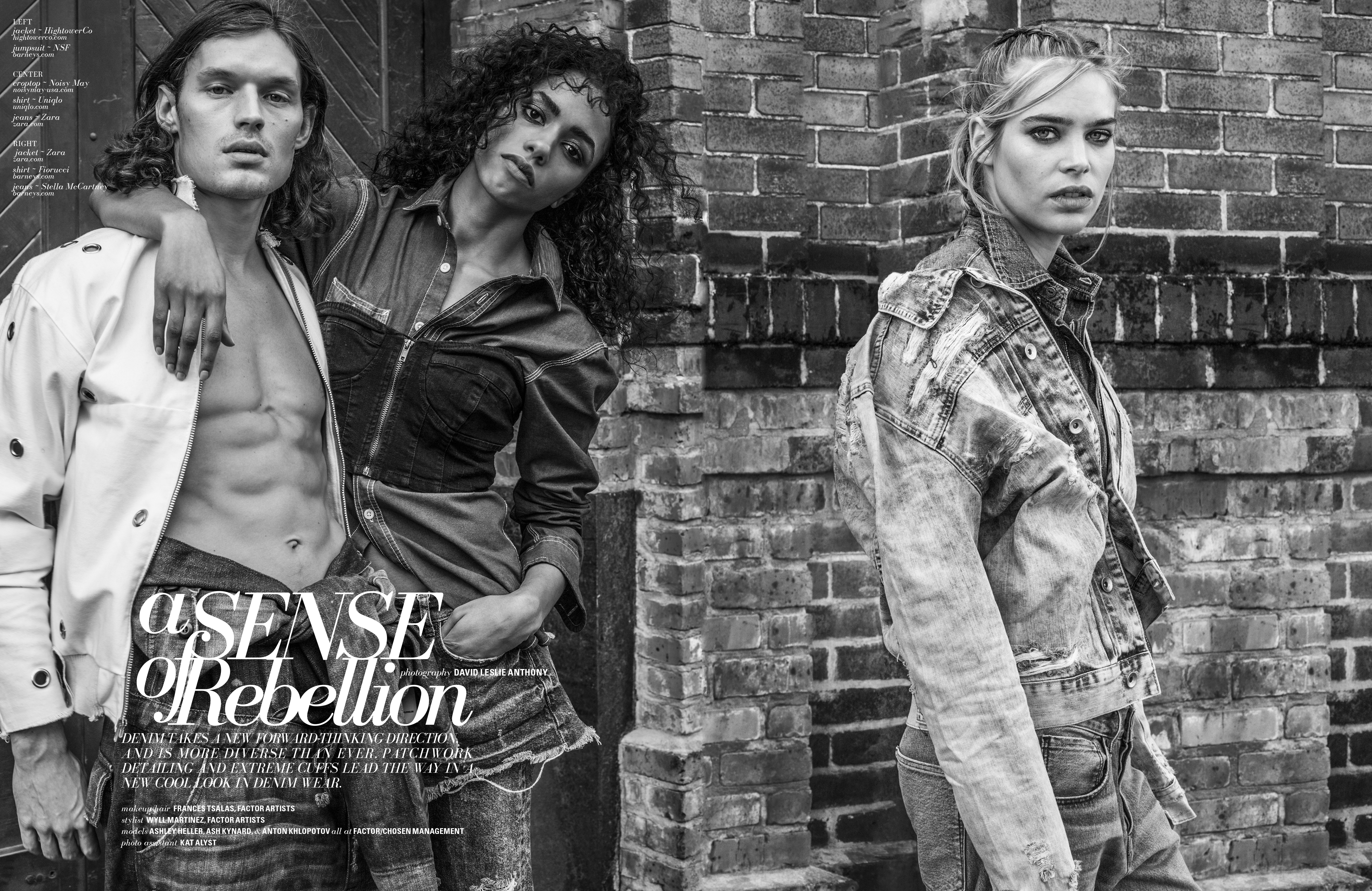 Black-and-white fashion shot of three models in denim and white jacket, posing against a brick wall in an outdoor setting.