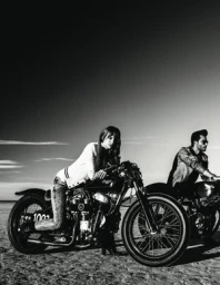 Monochrome photograph of a woman leaning on a vintage motorcycle outdoors with a man on another bike nearby in Los Angeles.