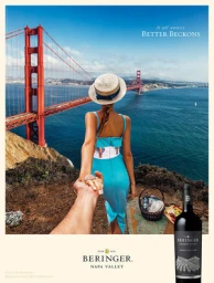 Woman in blue dress and straw hat holding hand with Golden Gate Bridge in background