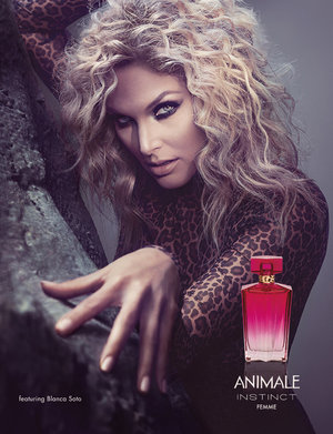 A fashion and beauty advertisement featuring a blonde woman wearing a leopard print top with a bottle of perfume to the right.