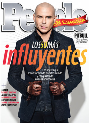 People en Español magazine cover featuring Pitbull wearing a dark jacket, leather gloves, and a serious expression, against a white background.