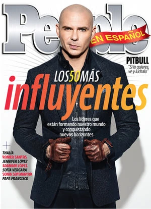 People en Español magazine cover featuring Pitbull wearing a dark jacket, leather gloves, and a serious expression, against a white background.