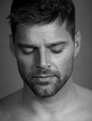 Close-up black and white portrait of musician Maury Hechavarria with eyes closed in a studio setting.