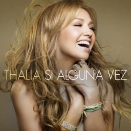Portrait of singer Thalia smiling with long blonde hair against a warm tan background featuring layered bracelets and rings