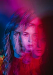 Multiple exposure portrait of a woman with layered red and blue lighting effects by photographers Murad and Nataly Osmann.