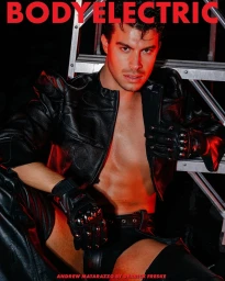 Man wearing a black leather jacket and studded gloves posing in front of a metal ladder with red lighting