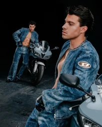 Two men in denim outfits posing with sport bikes against a dark background in Los Angeles by photographer Derrick Freske.