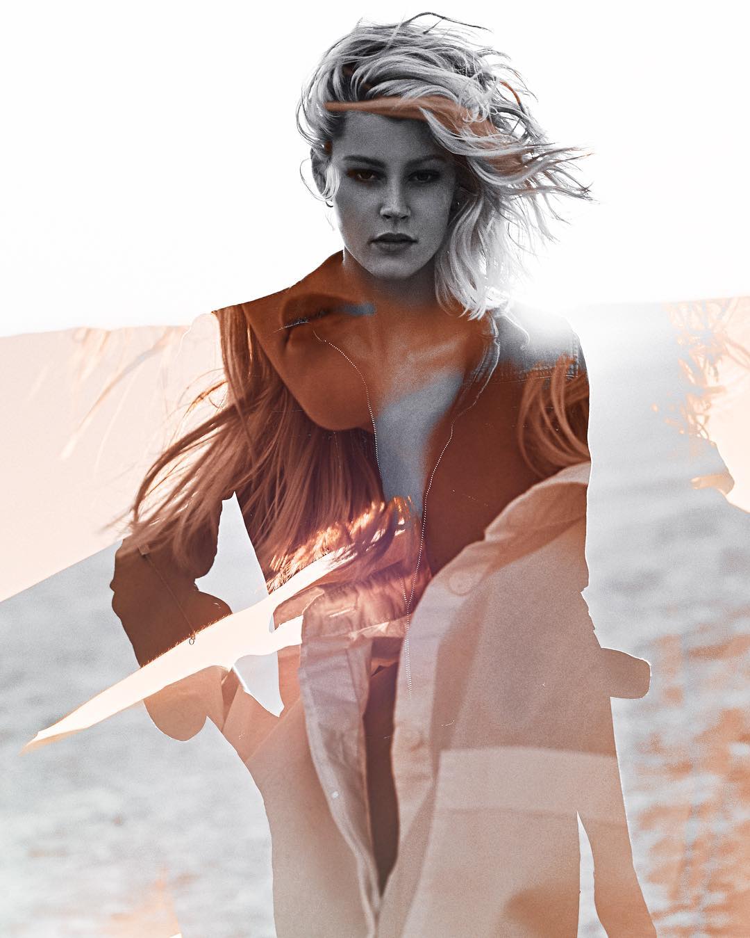 Portrait of a woman with layered photo effect, showcasing her face in grayscale with overlay of body in shades of orange and white.