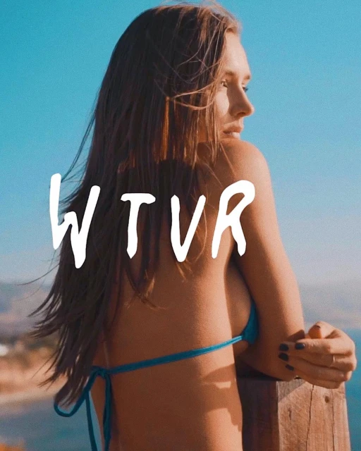 Woman in bikini stands by wooden railing with ocean and blue sky backdrop. Text overlay reads 'WTVR' in bold white letters.