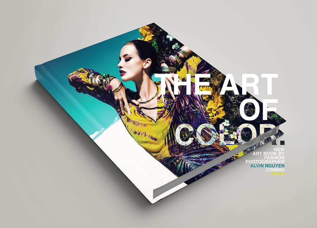 Fashion book cover featuring a model in a yellow dress and jewelry against a blue sky, promoting 'The Art of Color' art book.