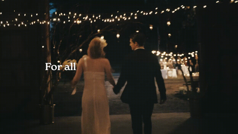Silhouetted couple walks away hand-in-hand at night toward wedding reception. String lights and dining tables in background.