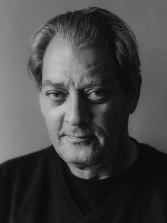 Black and white portrait of a man in his 50s wearing a dark sweater against a plain background