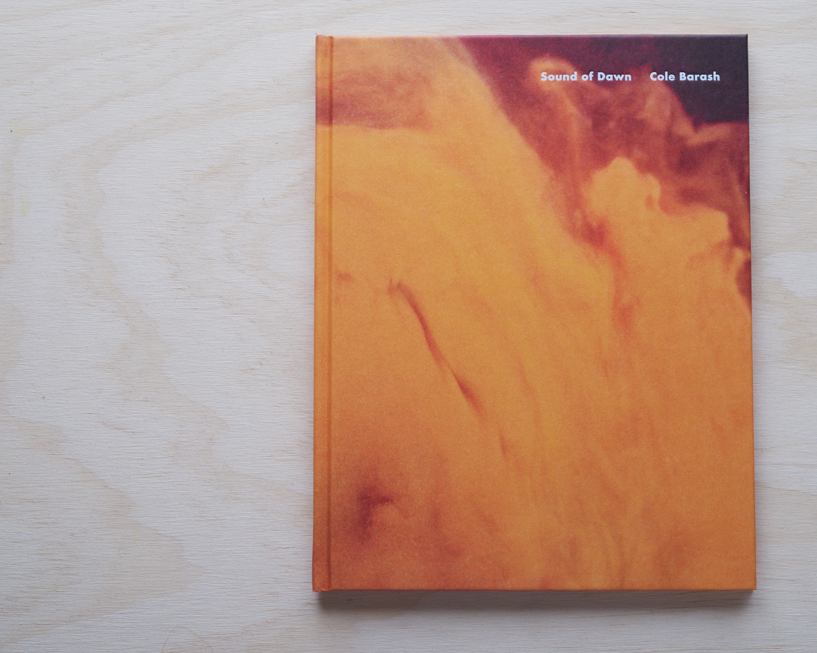 Book cover featuring a blurred abstract design in shades of orange and brown. The title 'Sound of Dawn' by Cole Barash is visible.