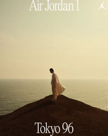 Person in flowing white clothing on a hilltop overlooking the ocean at sunset. 'Air Jordan 1' and 'Tokyo 96' text overlays.