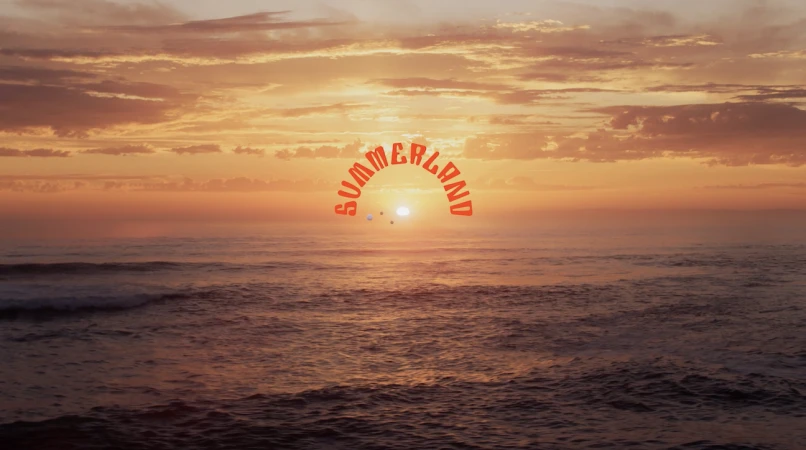 Sunset over the ocean with orange sky, clouds, and water. The word Summerland is superimposed in orange, following the horizon.
