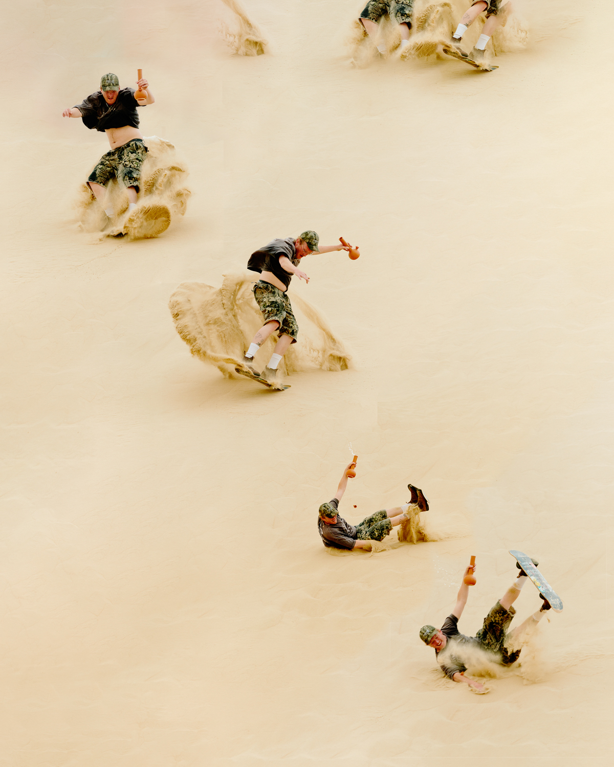 A sandboarding montage featuring multiple shots of an adult male sandboarding down a dune in a desert landscape on a bright, sunny day.
