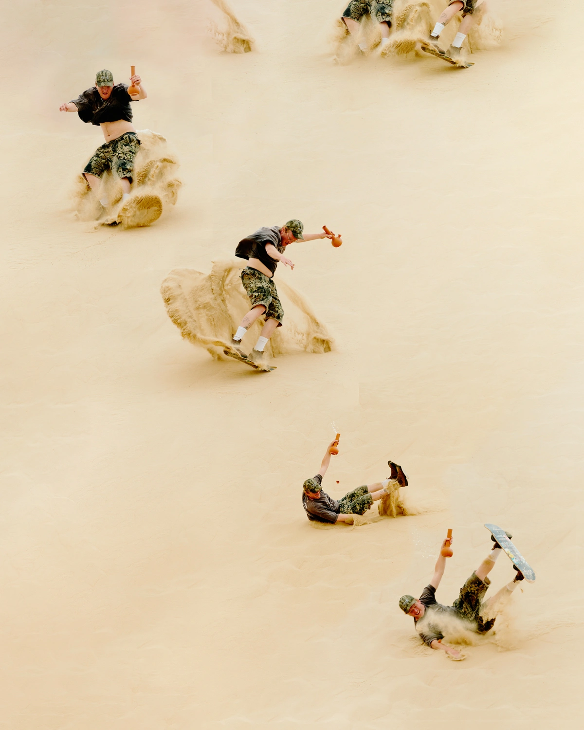 Multiple exposure action photograph of a sandboarder wiping out on a steep sand dune, captured by Frankie Carino.