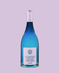 Blue wine bottle with light pink label and foil-wrapped neck centered against a solid pastel lilac background.
