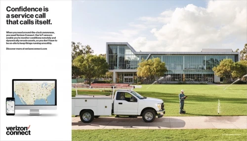 Commercial ad featuring a white utility truck, a maintenance worker, a building, lawn sprinklers, and a Verizon Connect ad on a monitor.