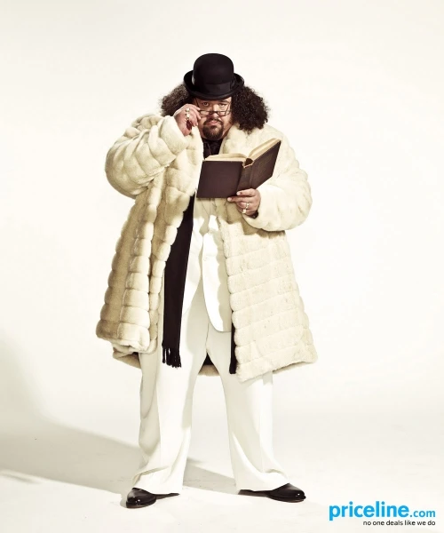 Man with beard and glasses wearing fur coat and top hat reading book on white background; Priceline logo is visible.
