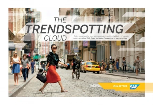 Woman walking across a cobblestone city street holding a handbag, photographed by Bryce Duffy in a busy urban commercial setting.