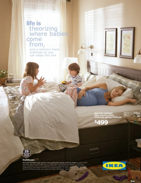 Pregnant woman lies on a memory foam mattress with two children. Ikea ad for Sultan Hansbo pillowtop spring mattress. Home setting.