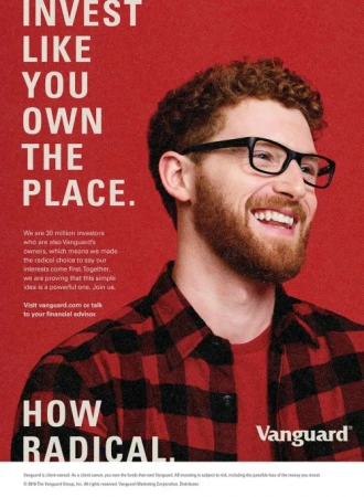Smiling man with glasses in a flannel shirt against a red background, financial advertisement for Vanguard with the text 'Invest Like You Own The Place'.