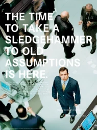 High-angle view of a man in a blue suit looking up on a trading floor surrounded by people, captured by Bryce Duffy.