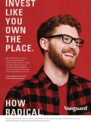 Smiling red-headed man with glasses wearing a red plaid shirt against a solid red background with text.