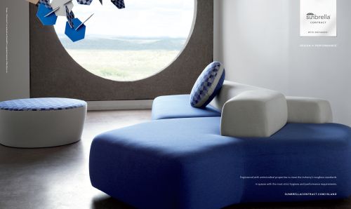 Modern interior design featuring a modular blue and white sofa, ottoman, round window, and geometric hanging decoration for a stylish living space.