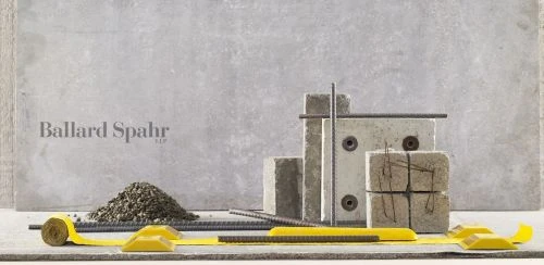 Still life featuring concrete blocks, rebar, a pile of gravel, and yellow supports against a mottled gray backdrop.