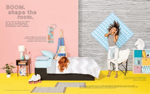 Bedroom interior with two young women: one lying on the bed with legs up, another standing wearing headphones in a bright, colorful room.
