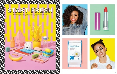 Vibrant flat lay with beauty products, office supplies, banana, and cleaning supplies on a pink desk, framed by a black and white pattern.