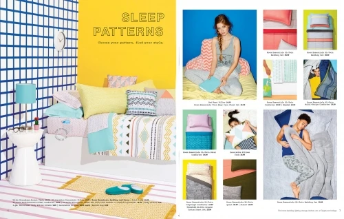 Interior setting featuring bedding product placement, showcasing various patterns and designs against a brightly colored and patterned backdrop.