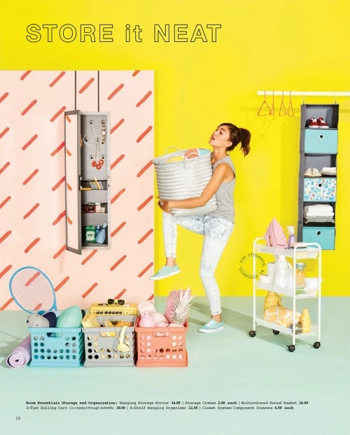 Young woman carries laundry basket in bright room with storage solutions, including shelving, rolling cart, and storage mirror.