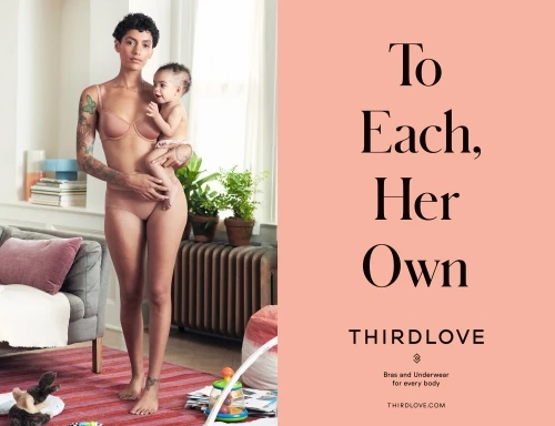 A woman holds a baby indoors, wearing matching bra and underwear, next to brand messaging, promoting body positivity and comfort.