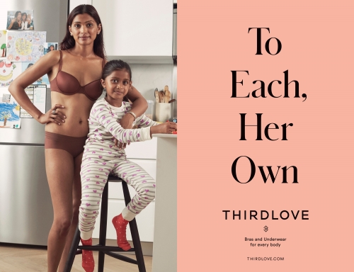 Mother and daughter pose in kitchen; mother in lingerie, daughter in pajamas, next to ThirdLove ad. Supportive family theme.